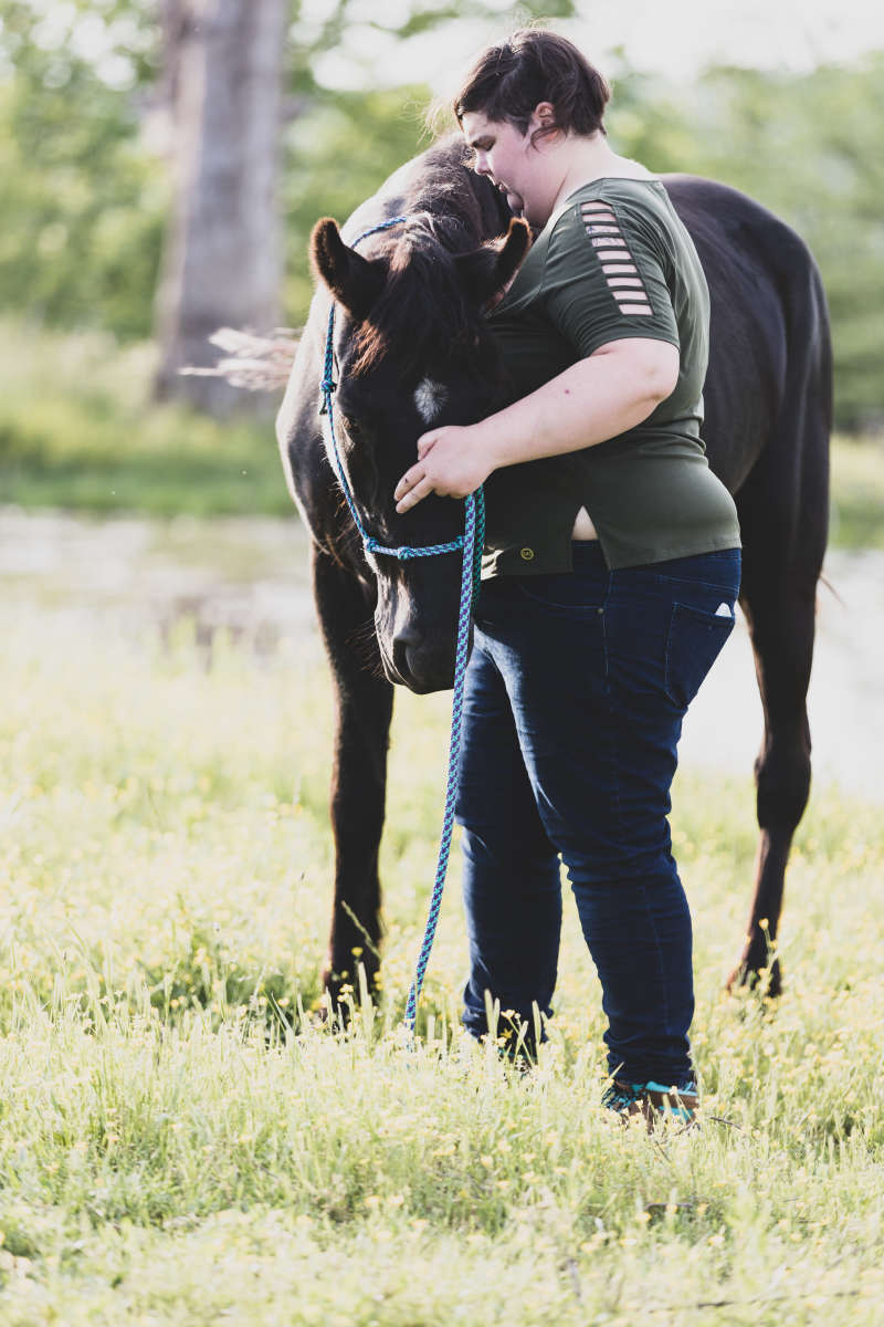 Woman hugging horse